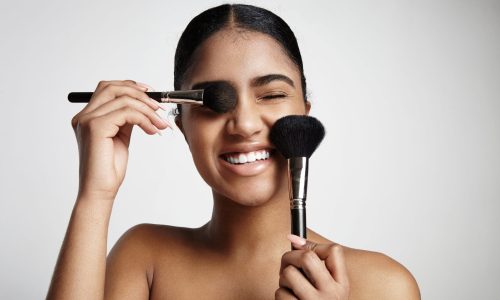 woman have fun with a cosmetic brushes